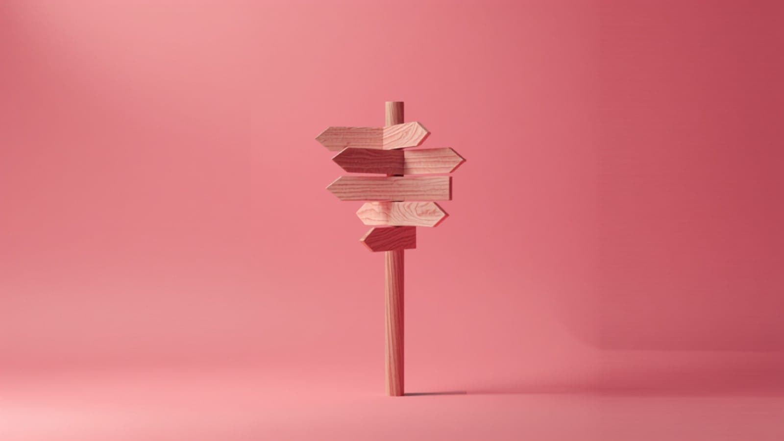 A single tall signpost on a soft pink studio backdrop with arrows pointing in several directions, standing in for a complete guide to influencer marketing in India
