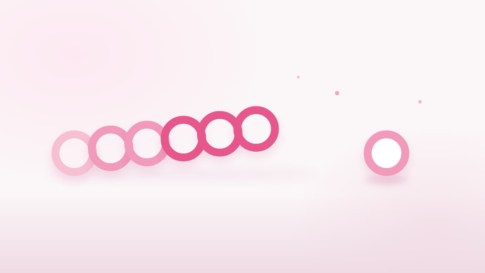 A chain of six linked pink rings beside one ring standing alone on a pale surface, for a post comparing long-term creator partnerships with one-off influencer campaigns