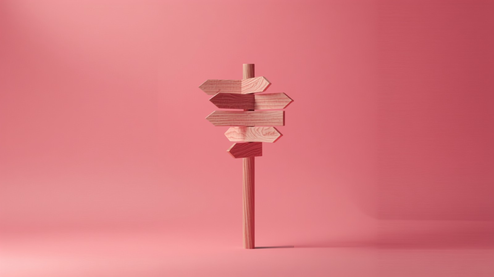 A single tall signpost on a soft pink studio backdrop with arrows pointing in several directions, standing in for a complete guide to influencer marketing in India
