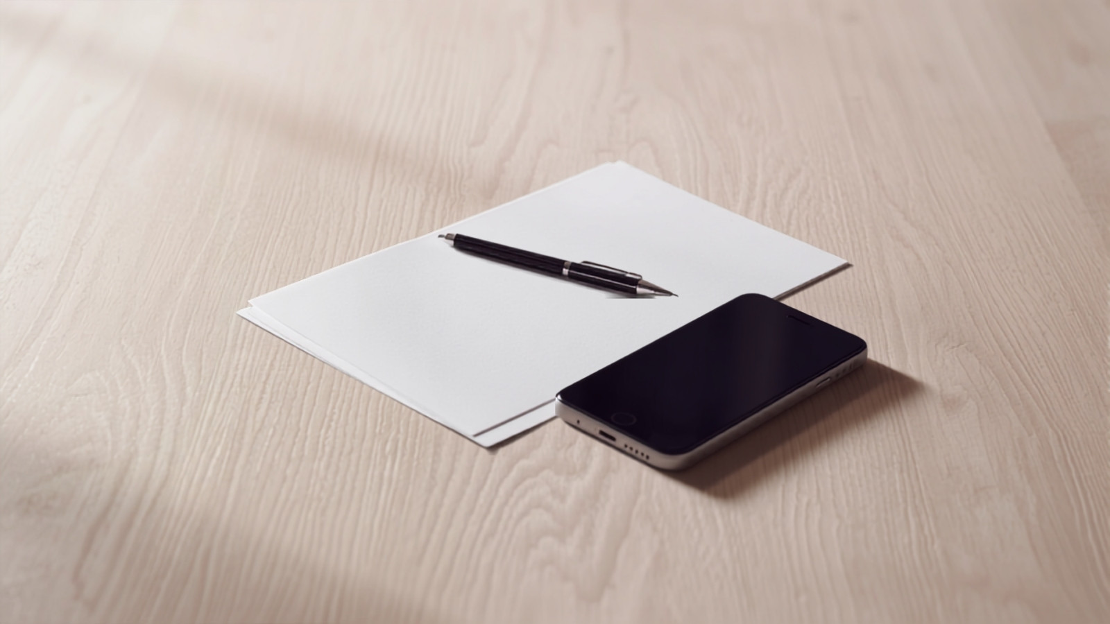 A printed collaboration agreement resting beside a phone on a plain desk, illustrating how Indian creators price usage rights and whitelisting separately from the content itself